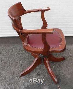 1920's Leather Oak Office chair. Leather Seat carved back. On castors