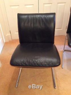 Boss Chairs black leather with tan leather piping. Set of 4