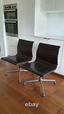 Pair of vintage Vitra Eames chairs in dark brown leather home office / study