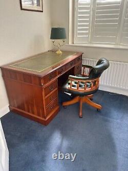 Reproduction office table, leather captains swivel chair and desk lamp